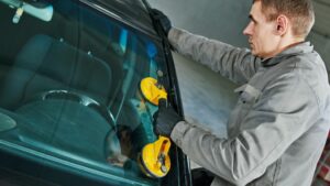 technician doing windshield replacement in Houston